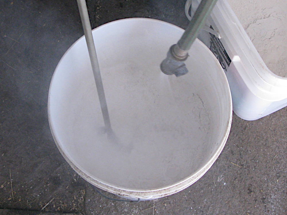 Mixing lime and water to make whitewash