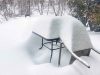 Table and chair under snow