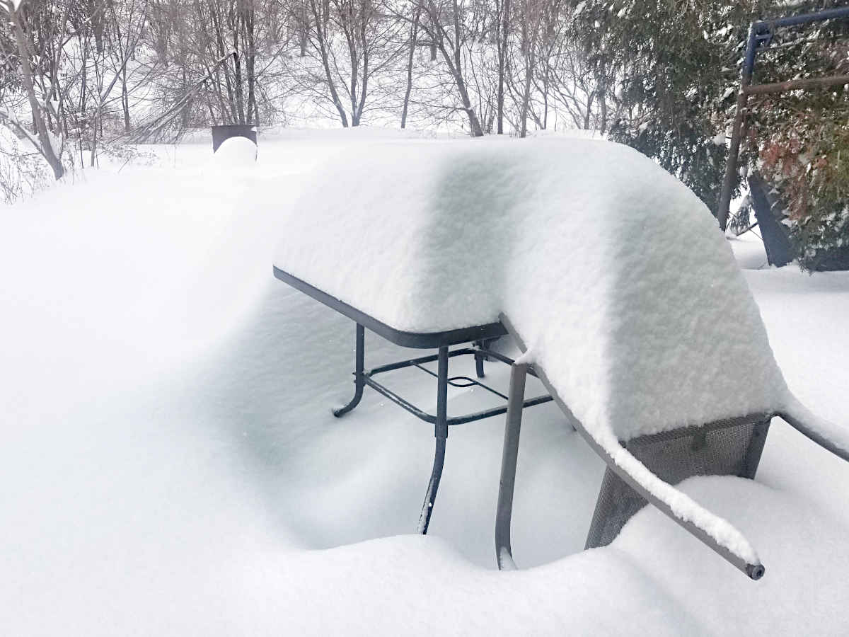 Table and chair under snow