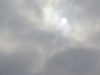 The Sun breaking through fog and clouds as a perfect white disk